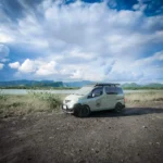 East Bali Campervan parked near coastal cliffs with ocean views and tropical greenery, ideal for flexible road trips, hotel-free exploration, and nature-based travel experiences.
