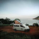 BALI CAMPERVAN RENTAL, Camping with campervan in Bali featuring van parked at scenic highland site with sunrise glow, forest surroundings, and cozy outdoor setup — perfect for nature lovers and flexible travel enthusiasts.