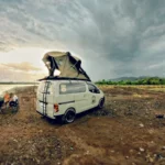 CAMPERVAN - EN - Home 22 Bali campervan - traveler duduk di kursi lipat depan campervan Bali