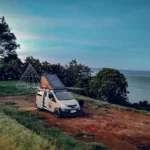 CAMPERVAN - EN - Home 20 Campervan East Bali diparkir di tengah lanskap hijau Karangasem dengan gunung di kejauhan