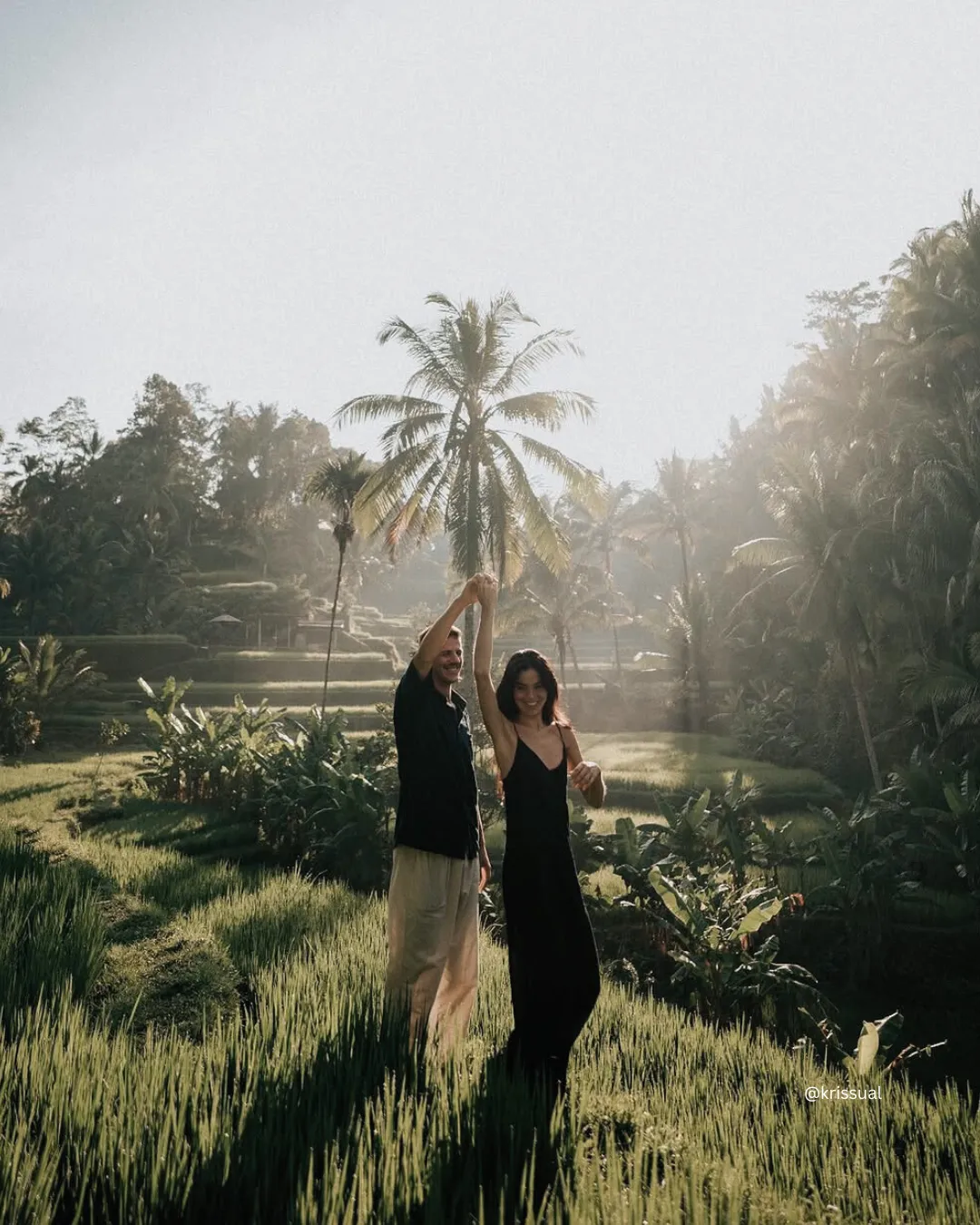 Couple standing together at Tegalalang Rice Terraces with lush green landscape in Bali.