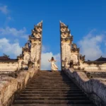 Sunrise glow over Mount Agung framed by the stone dragon staircase at Lempuyang Temple Bali.